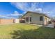Expansive backyard featuring lush lawn, storage shed, block wall, and a covered patio perfect for outdoor entertaining at 3418 W Maldonado Rd, Phoenix, AZ 85041