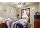 Cozy bedroom with a ceiling fan, window and a comfortable bed for a relaxing ambiance at 3418 W Maldonado Rd, Phoenix, AZ 85041
