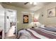 Bedroom view showcasing doorway, closet, fan, window, artwork, and furnishings at 3418 W Maldonado Rd, Phoenix, AZ 85041