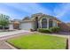 Inviting single-story home with a well-manicured lawn, landscaping, and a two-car garage at 3418 W Maldonado Rd, Phoenix, AZ 85041