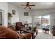 Warm living room with hardwood floors and a sliding glass door to a patio with chairs and a table at 3418 W Maldonado Rd, Phoenix, AZ 85041
