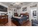 Warm, inviting main bedroom with wood floors and natural light from large windows at 3418 W Maldonado Rd, Phoenix, AZ 85041