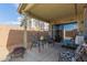 Covered patio with seating, offering a cozy outdoor living space, and a view of the backyard at 3418 W Maldonado Rd, Phoenix, AZ 85041