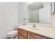 Bathroom with wood vanity, mirror, and toilet at 3511 E Baseline Rd # 1085, Phoenix, AZ 85042