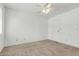 A bedroom featuring a ceiling fan and neutral carpet leading to a white door at 3511 E Baseline Rd # 1085, Phoenix, AZ 85042