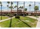 Exterior view of building featuring well-maintained lawn, desert landscaping, and a charming desert home at 3511 E Baseline Rd # 1085, Phoenix, AZ 85042