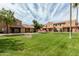 Community exterior featuring well-maintained lawn, desert landscaping, and a beautiful view of the neighborhood at 3511 E Baseline Rd # 1085, Phoenix, AZ 85042