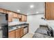 Functional kitchen showcasing granite countertops and black appliances at 3511 E Baseline Rd # 1085, Phoenix, AZ 85042