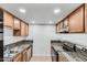 Efficient kitchen with granite countertops, stainless sink and black range at 3511 E Baseline Rd # 1085, Phoenix, AZ 85042