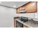 Efficient kitchen featuring laminate cabinets and granite countertops at 3511 E Baseline Rd # 1085, Phoenix, AZ 85042