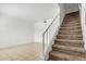Carpeted staircase leading to upstairs, with tile flooring in the entry area at 3511 E Baseline Rd # 1085, Phoenix, AZ 85042