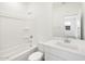 Bright bathroom featuring a bathtub, shower, and a vanity with solid countertops at 37069 W Prado St, Maricopa, AZ 85138