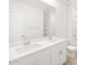 Bright bathroom featuring a double vanity with white cabinets and a large mirror at 37069 W Prado St, Maricopa, AZ 85138