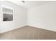 Cozy bedroom with neutral carpet, a large window, and ample natural light at 37069 W Prado St, Maricopa, AZ 85138