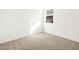 Clean, cozy bedroom, brightened by natural light, featuring neutral carpet and a minimalist aesthetic for relaxation at 37069 W Prado St, Maricopa, AZ 85138