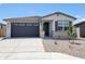 Charming single-story home featuring a well-maintained yard and a two-car garage at 37069 W Prado St, Maricopa, AZ 85138