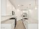 Bright kitchen featuring white cabinets, granite countertops, a kitchen island, and stainless steel appliances at 37069 W Prado St, Maricopa, AZ 85138