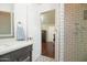 Modern bathroom with a vanity, sink, mirror and glass shower door with white tiling at 4010 E Catalina Dr, Phoenix, AZ 85018