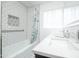 Updated bathroom featuring tiled shower/tub combo, updated vanity with dual sinks and hexagonal floor tiles at 4010 E Catalina Dr, Phoenix, AZ 85018