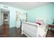 Bright bedroom featuring a built-in desk, ample shelving, and stylish decor at 4010 E Catalina Dr, Phoenix, AZ 85018