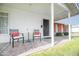 Cozy front porch featuring two chairs, a table, and a decorative outdoor rug at 4010 E Catalina Dr, Phoenix, AZ 85018