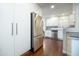 Modern kitchen with stainless steel refrigerator, white cabinets, and hardwood floors at 4010 E Catalina Dr, Phoenix, AZ 85018