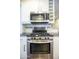 Close-up of a stainless steel oven and microwave in a bright and modern kitchen at 4010 E Catalina Dr, Phoenix, AZ 85018