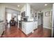 Bright kitchen with stainless steel appliances, white cabinetry, and hardwood floors, plus dining area at 4010 E Catalina Dr, Phoenix, AZ 85018