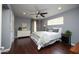 Cozy main bedroom with hardwood floors, ceiling fan, dresser and a comfortable bed at 4010 E Catalina Dr, Phoenix, AZ 85018