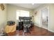 Home office space includes a triple monitor setup, office chair, and a view to the bathroom at 4010 E Catalina Dr, Phoenix, AZ 85018