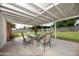 Outdoor patio with covered pergola, dining table and chairs, and spacious backyard at 4010 E Catalina Dr, Phoenix, AZ 85018