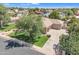 An elevated view capturing the home's manicured lawn, mature shade tree and lengthy driveway at 4061 E Hope St, Mesa, AZ 85205