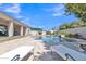 Backyard featuring a pool, lounge chairs, landscaping, covered patio, and blue sky at 4061 E Hope St, Mesa, AZ 85205