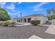 Home exterior view showcasing a private backyard with pool, covered patio, and desert landscaping at 4061 E Hope St, Mesa, AZ 85205