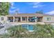 Backyard featuring a pool, landscaping, covered patio, and view of the house at 4061 E Hope St, Mesa, AZ 85205