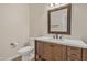 Cozy bathroom features wood vanity, framed mirror, and tile flooring at 4061 E Hope St, Mesa, AZ 85205