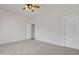 Bedroom features neutral carpet, ceiling fan, and white doors at 4061 E Hope St, Mesa, AZ 85205