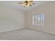 Spacious bedroom with neutral carpet, ceiling fan, and window with shutters at 4061 E Hope St, Mesa, AZ 85205