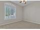 Bright bedroom with neutral carpet and window with white plantation shutters at 4061 E Hope St, Mesa, AZ 85205