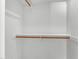 White walk-in closet featuring wooden racks and shelves at 4061 E Hope St, Mesa, AZ 85205
