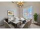 Elegant dining room featuring a marble table, chandelier lighting, and bright window views at 4061 E Hope St, Mesa, AZ 85205