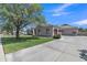 Charming single-story home featuring a well-manicured lawn and spacious driveway at 4061 E Hope St, Mesa, AZ 85205