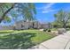 Charming single-story home with well-manicured lawn and mature trees at 4061 E Hope St, Mesa, AZ 85205
