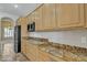 Well-equipped kitchen with stainless steel appliances, granite counters and wood cabinets at 4061 E Hope St, Mesa, AZ 85205