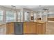 Granite countertops and stainless steel dishwasher overlooking the fireplace and bay windows at 4061 E Hope St, Mesa, AZ 85205