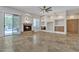 Large living room featuring a fireplace, built-in shelves, and travertine floors at 4061 E Hope St, Mesa, AZ 85205