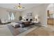 Bright main bedroom with neutral colors and a comfortable seating area at 4061 E Hope St, Mesa, AZ 85205