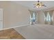 Spacious main bedroom with light-colored walls, carpet, and a ceiling fan at 4061 E Hope St, Mesa, AZ 85205