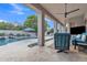 Covered patio featuring outdoor seating, tile flooring, ceiling fan, and a view of the pool at 4061 E Hope St, Mesa, AZ 85205