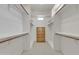 Spacious walk-in closet with custom wood shelving and built-in wooden dresser at 4061 E Hope St, Mesa, AZ 85205